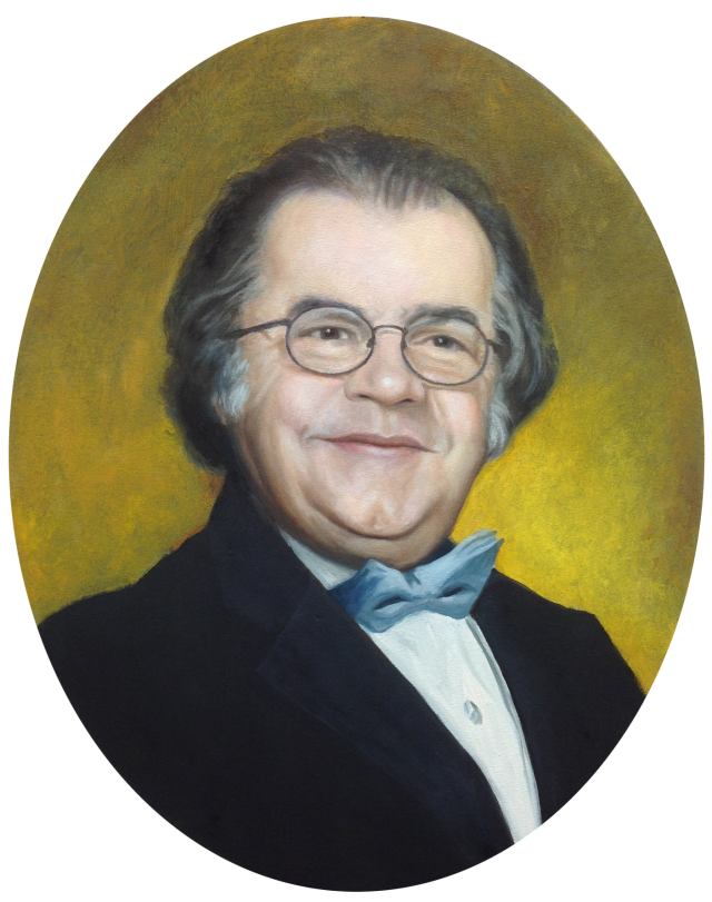 Retrato ovalado de un hombre sonriente con gafas y cabello gris, vistiendo una camisa blanca y un bowtie azul oscuro, con un fondo amarillo.